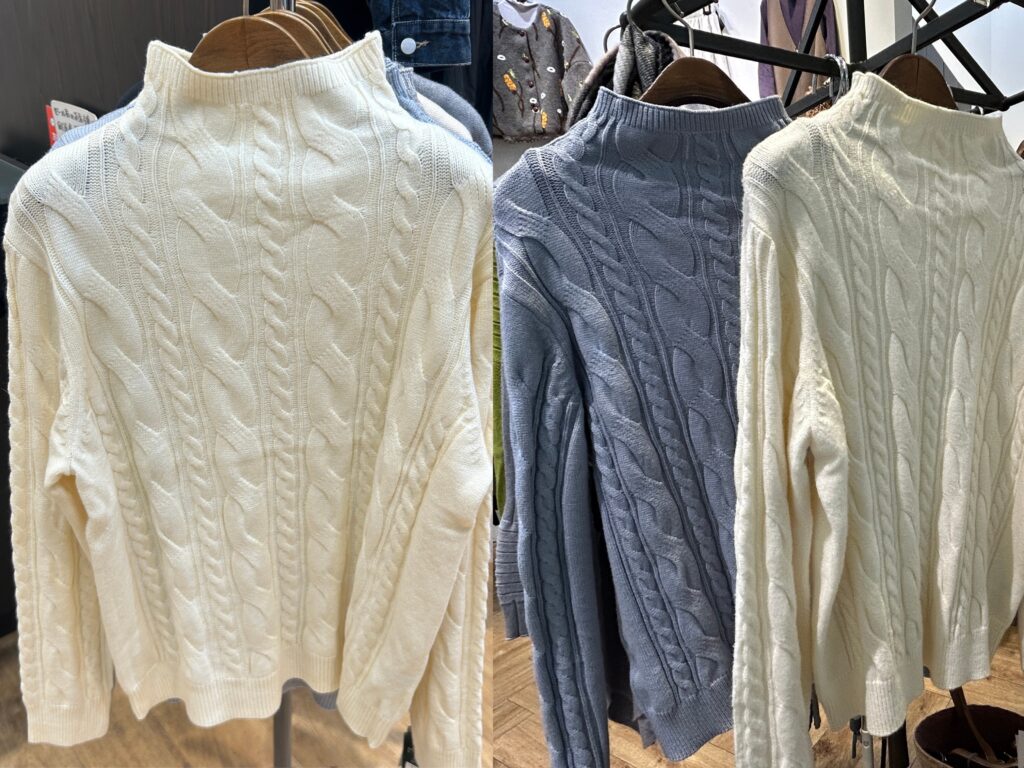 ケーブル編みの長袖ニット。